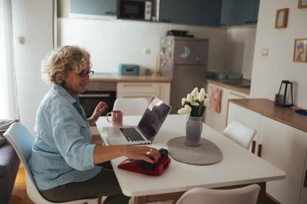 Older woman checking 2027 Medicare Part B premium details on a laptop at home