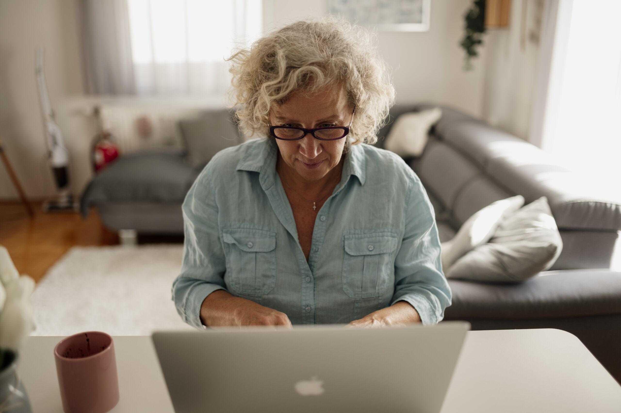Older woman reviewing 2027 Medicare Part B premium information on a laptop.