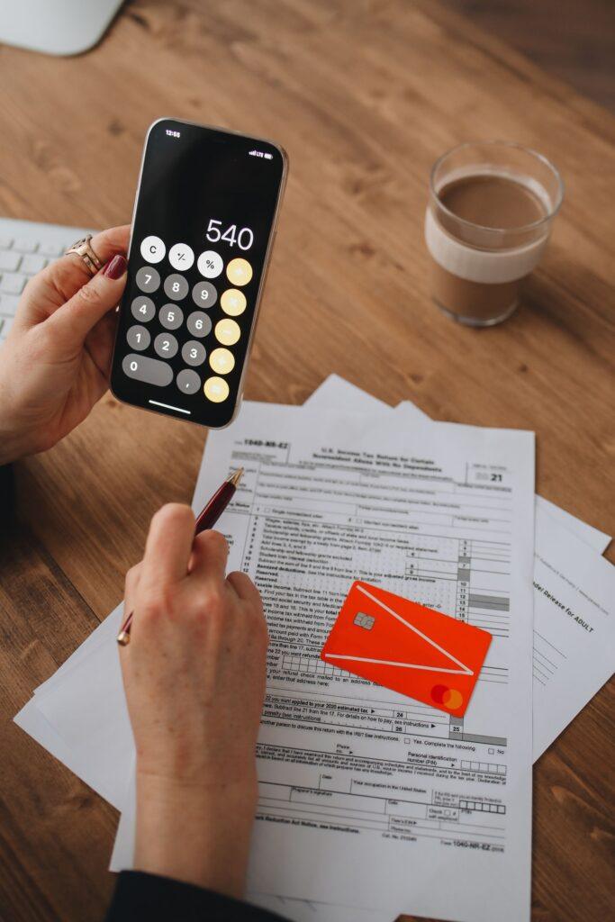 IRS CP53E notice refund status checked on a phone beside tax documents